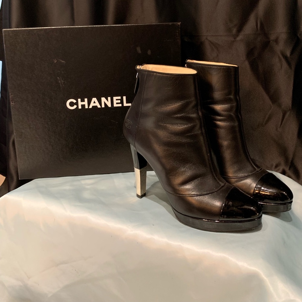 Chanel black leather booties with stiletto heels.